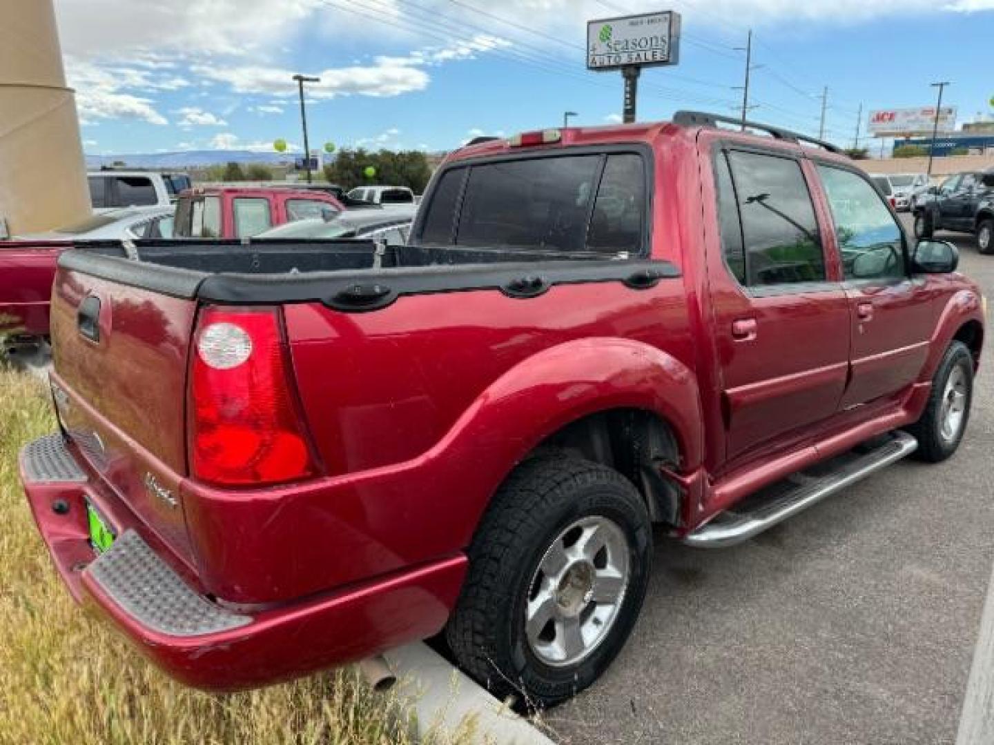 2004 Red Fire Metallic /Medium Dark Flint Cloth Interior Ford Explorer Sport Trac XLT 2WD (1FMZU67K24U) with an 4.0L V6 SOHC 12V FFV engine, 5-Speed Automatic transmission, located at 1865 East Red Hills Pkwy, St. George, 84770, (435) 628-0023, 37.120850, -113.543640 - This vehicle is a Mechanic Special. This means it will need some love. Runs a drives fine but has body damage, leaks or other mechanical issues. It did NOT pass our 50 point inspection. Get a great deal on a less than perfect car. These cars do NOT qualify for our in house financing. Cash and carry, - Photo#3