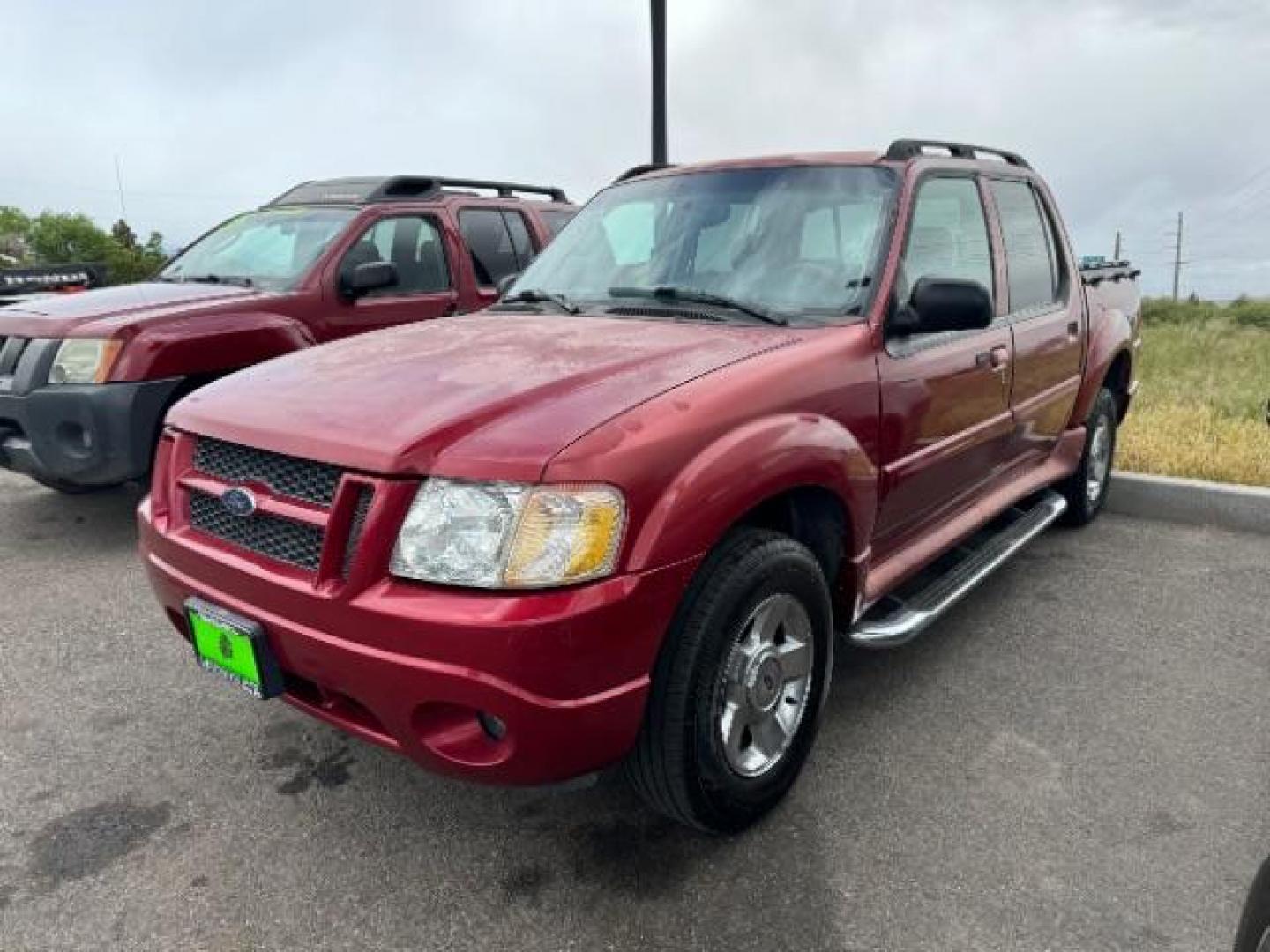 2004 Red Fire Metallic /Medium Dark Flint Cloth Interior Ford Explorer Sport Trac XLT 2WD (1FMZU67K24U) with an 4.0L V6 SOHC 12V FFV engine, 5-Speed Automatic transmission, located at 1865 East Red Hills Pkwy, St. George, 84770, (435) 628-0023, 37.120850, -113.543640 - This vehicle is a Mechanic Special. This means it will need some love. Runs a drives fine but has body damage, leaks or other mechanical issues. It did NOT pass our 50 point inspection. Get a great deal on a less than perfect car. These cars do NOT qualify for our in house financing. Cash and carry, - Photo#2