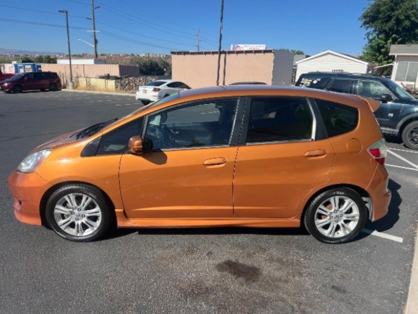 2009 Orange Revolution Metallic /Black Cloth Interior Honda Fit Sport 5-Speed AT (JHMGE88409S) with an 1.5L L4 SOHC 16V engine, 5-Speed Automatic transmission, located at 1865 East Red Hills Pkwy, St. George, 84770, (435) 628-0023, 37.120850, -113.543640 - We specialize in helping ALL people get the best financing available. No matter your credit score, good, bad or none we can get you an amazing rate. Had a bankruptcy, divorce, or repossessions? We give you the green light to get your credit back on the road. Low down and affordable payments that fit- Photo#3