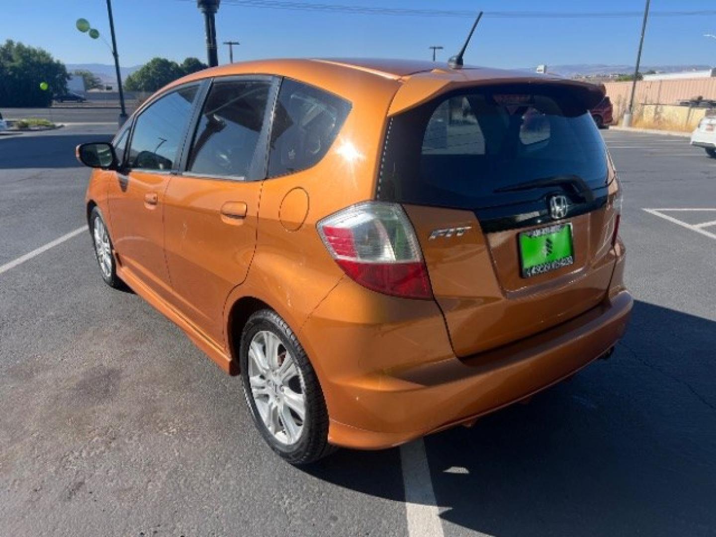2009 Orange Revolution Metallic /Black Cloth Interior Honda Fit Sport 5-Speed AT (JHMGE88409S) with an 1.5L L4 SOHC 16V engine, 5-Speed Automatic transmission, located at 1865 East Red Hills Pkwy, St. George, 84770, (435) 628-0023, 37.120850, -113.543640 - We specialize in helping ALL people get the best financing available. No matter your credit score, good, bad or none we can get you an amazing rate. Had a bankruptcy, divorce, or repossessions? We give you the green light to get your credit back on the road. Low down and affordable payments that fit- Photo#4