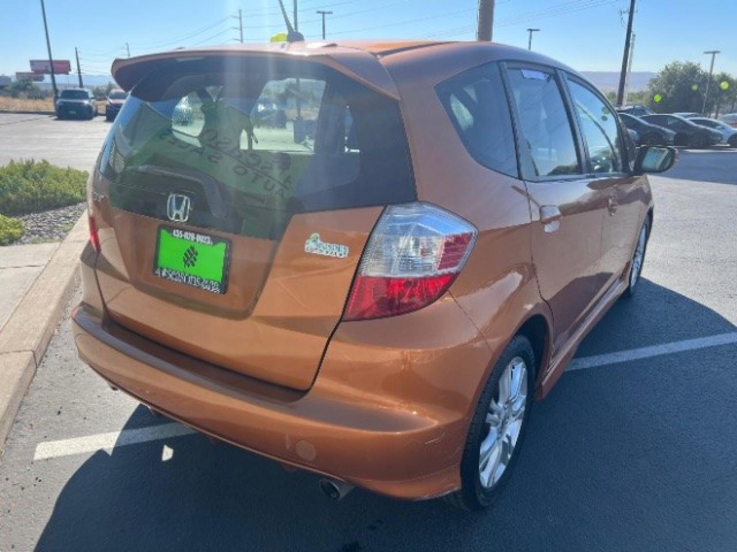 2009 Orange Revolution Metallic /Black Cloth Interior Honda Fit Sport 5-Speed AT (JHMGE88409S) with an 1.5L L4 SOHC 16V engine, 5-Speed Automatic transmission, located at 1865 East Red Hills Pkwy, St. George, 84770, (435) 628-0023, 37.120850, -113.543640 - We specialize in helping ALL people get the best financing available. No matter your credit score, good, bad or none we can get you an amazing rate. Had a bankruptcy, divorce, or repossessions? We give you the green light to get your credit back on the road. Low down and affordable payments that fit- Photo#6