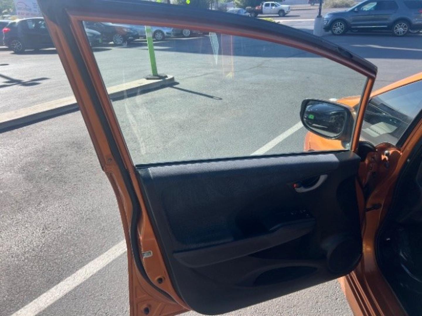 2009 Orange Revolution Metallic /Black Cloth Interior Honda Fit Sport 5-Speed AT (JHMGE88409S) with an 1.5L L4 SOHC 16V engine, 5-Speed Automatic transmission, located at 1865 East Red Hills Pkwy, St. George, 84770, (435) 628-0023, 37.120850, -113.543640 - We specialize in helping ALL people get the best financing available. No matter your credit score, good, bad or none we can get you an amazing rate. Had a bankruptcy, divorce, or repossessions? We give you the green light to get your credit back on the road. Low down and affordable payments that fit- Photo#12