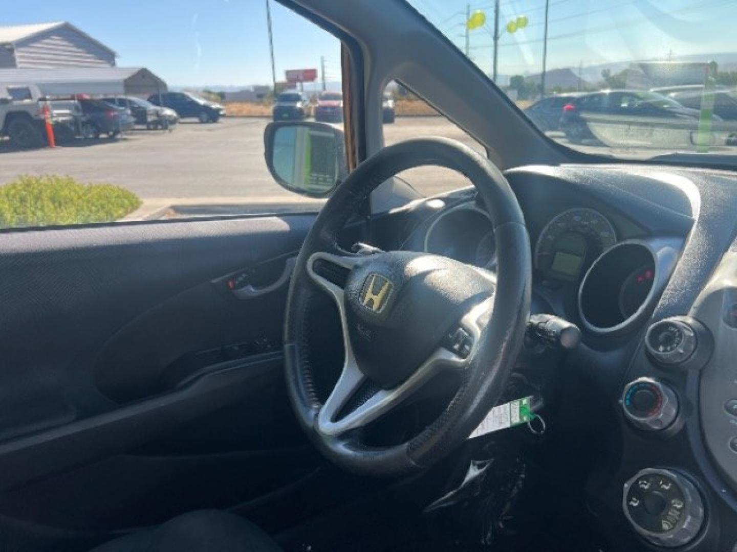 2009 Orange Revolution Metallic /Black Cloth Interior Honda Fit Sport 5-Speed AT (JHMGE88409S) with an 1.5L L4 SOHC 16V engine, 5-Speed Automatic transmission, located at 1865 East Red Hills Pkwy, St. George, 84770, (435) 628-0023, 37.120850, -113.543640 - We specialize in helping ALL people get the best financing available. No matter your credit score, good, bad or none we can get you an amazing rate. Had a bankruptcy, divorce, or repossessions? We give you the green light to get your credit back on the road. Low down and affordable payments that fit- Photo#28