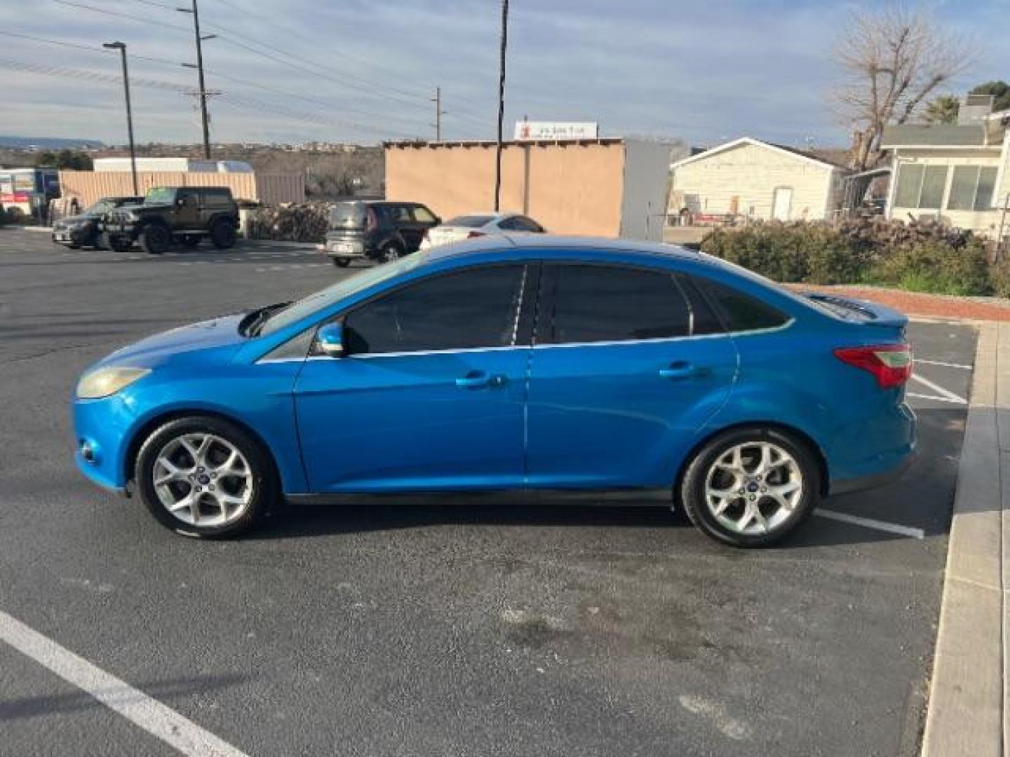 2014 Blue Candy Tinted CC /Charcoal Black Ford Focus Titanium Sedan (1FADP3J2XEL) with an 2.0L L4 DOHC 16V engine, 6-Speed Automatic transmission, located at 1865 East Red Hills Pkwy, St. George, 84770, (435) 628-0023, 37.120850, -113.543640 - We specialize in helping ALL people get the best financing available. No matter your credit score, good, bad or none we can get you an amazing rate. Had a bankruptcy, divorce, or repossessions? We give you the green light to get your credit back on the road. Low down and affordable payments that fit - Photo#3