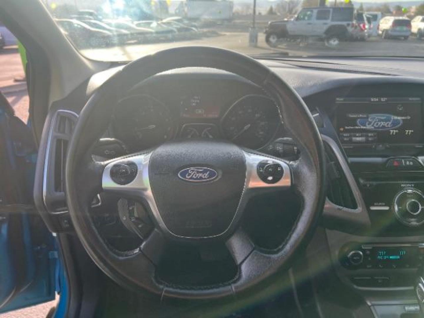 2014 Blue Candy Tinted CC /Charcoal Black Ford Focus Titanium Sedan (1FADP3J2XEL) with an 2.0L L4 DOHC 16V engine, 6-Speed Automatic transmission, located at 1865 East Red Hills Pkwy, St. George, 84770, (435) 628-0023, 37.120850, -113.543640 - We specialize in helping ALL people get the best financing available. No matter your credit score, good, bad or none we can get you an amazing rate. Had a bankruptcy, divorce, or repossessions? We give you the green light to get your credit back on the road. Low down and affordable payments that fit - Photo#15