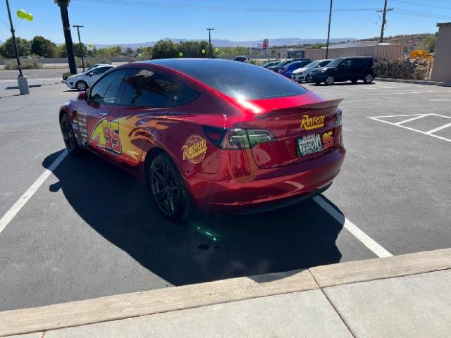 2018 Red /White Tesla Model 3 Long Range (5YJ3E1EB3JF) with an ELECTRIC engine, 1-Speed Automatic transmission, located at 1865 East Red Hills Pkwy, St. George, 84770, (435) 628-0023, 37.120850, -113.543640 - Your chance to own the most unique Tesla in town! Lightning McQueen is guaranteed to turn heads and make kids smile. A Long Range All Wheel Drive model 3 with aftermarket wheels ($1,000 Upgrade), spoiler and of course the coolest wrap in the state ($3,500 upgrade). WARRANTY on battery and motor un - Photo#4