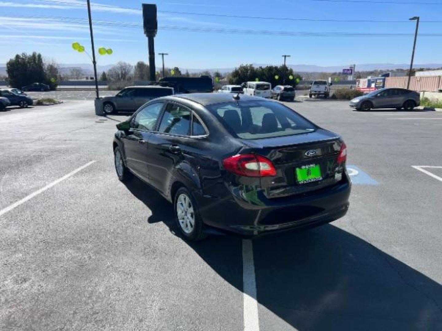 2012 Tuxedo Black Metallic /Charcoal Black/Light Stone Ford Fiesta SE (3FADP4BJ3CM) with an 1.6L I-4 DOHC engine, 5-Speed Manual transmission, located at 1865 East Red Hills Pkwy, St. George, 84770, (435) 628-0023, 37.120850, -113.543640 - Looking for a zippy, fuel-efficient car that is fun to drive and easy on your budget? This 2012 Ford Fiesta SE is just the ticket! Compact, stylish, and surprisingly well-equipped, this Fiesta comes loaded with air conditioning, heated front seats, chrome wheels, full size spare tire, deep tinted gl- Photo#4