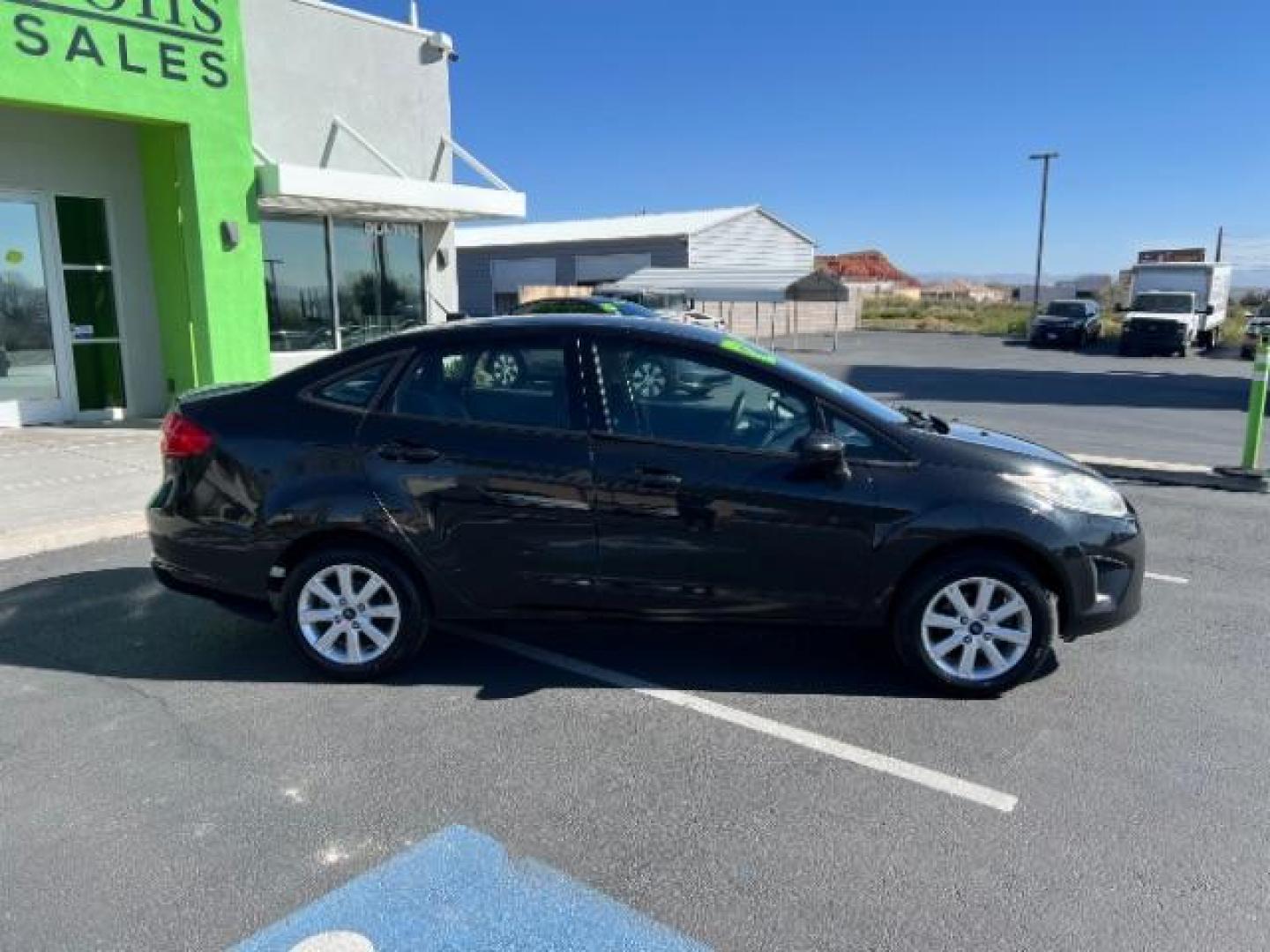 2012 Tuxedo Black Metallic /Charcoal Black/Light Stone Ford Fiesta SE (3FADP4BJ3CM) with an 1.6L I-4 DOHC engine, 5-Speed Manual transmission, located at 1865 East Red Hills Pkwy, St. George, 84770, (435) 628-0023, 37.120850, -113.543640 - Looking for a zippy, fuel-efficient car that is fun to drive and easy on your budget? This 2012 Ford Fiesta SE is just the ticket! Compact, stylish, and surprisingly well-equipped, this Fiesta comes loaded with air conditioning, heated front seats, chrome wheels, full size spare tire, deep tinted gl- Photo#7