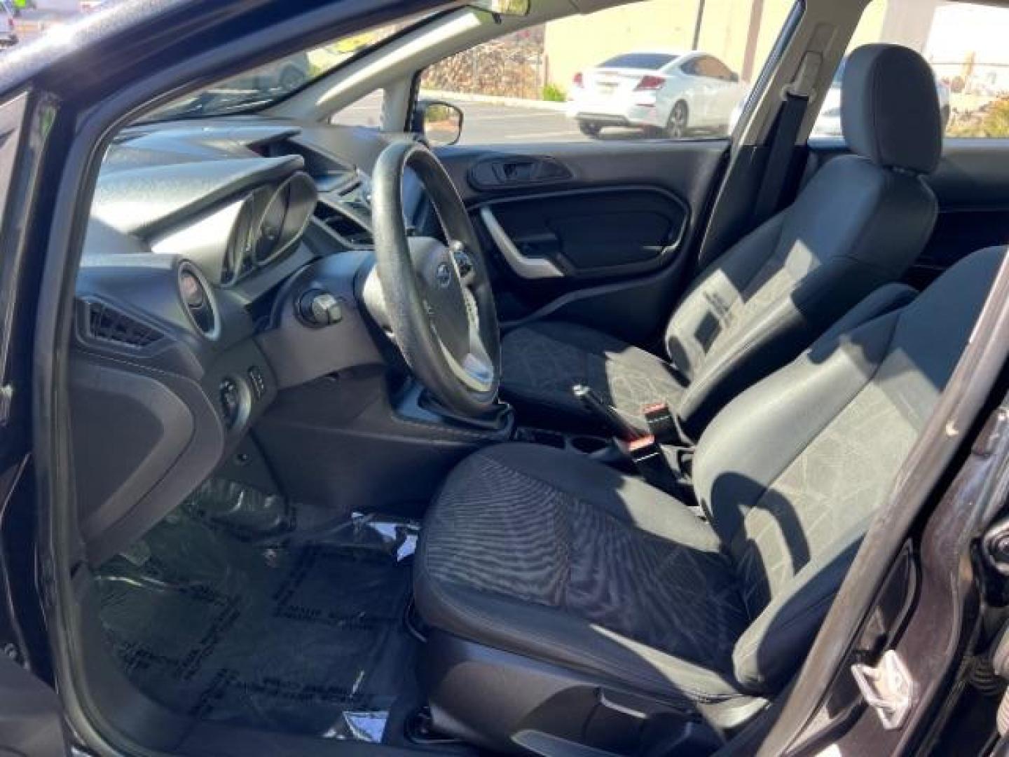 2012 Tuxedo Black Metallic /Charcoal Black/Light Stone Ford Fiesta SE (3FADP4BJ3CM) with an 1.6L I-4 DOHC engine, 5-Speed Manual transmission, located at 1865 East Red Hills Pkwy, St. George, 84770, (435) 628-0023, 37.120850, -113.543640 - Looking for a zippy, fuel-efficient car that is fun to drive and easy on your budget? This 2012 Ford Fiesta SE is just the ticket! Compact, stylish, and surprisingly well-equipped, this Fiesta comes loaded with air conditioning, heated front seats, chrome wheels, full size spare tire, deep tinted gl- Photo#14