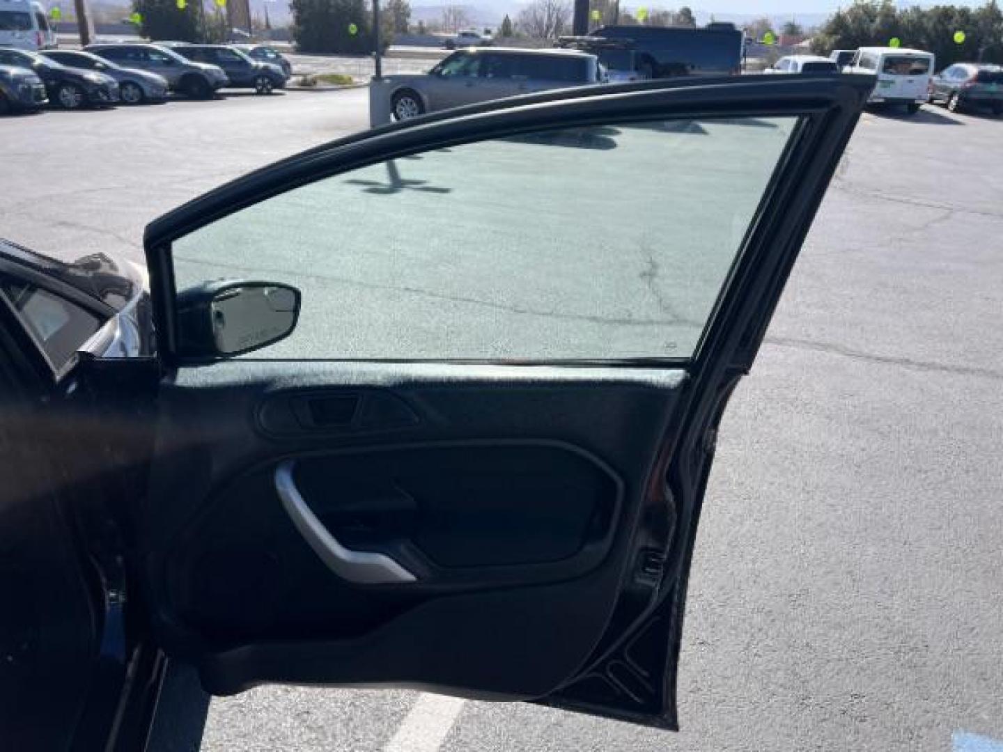 2012 Tuxedo Black Metallic /Charcoal Black/Light Stone Ford Fiesta SE (3FADP4BJ3CM) with an 1.6L I-4 DOHC engine, 5-Speed Manual transmission, located at 1865 East Red Hills Pkwy, St. George, 84770, (435) 628-0023, 37.120850, -113.543640 - Looking for a zippy, fuel-efficient car that is fun to drive and easy on your budget? This 2012 Ford Fiesta SE is just the ticket! Compact, stylish, and surprisingly well-equipped, this Fiesta comes loaded with air conditioning, heated front seats, chrome wheels, full size spare tire, deep tinted gl- Photo#25