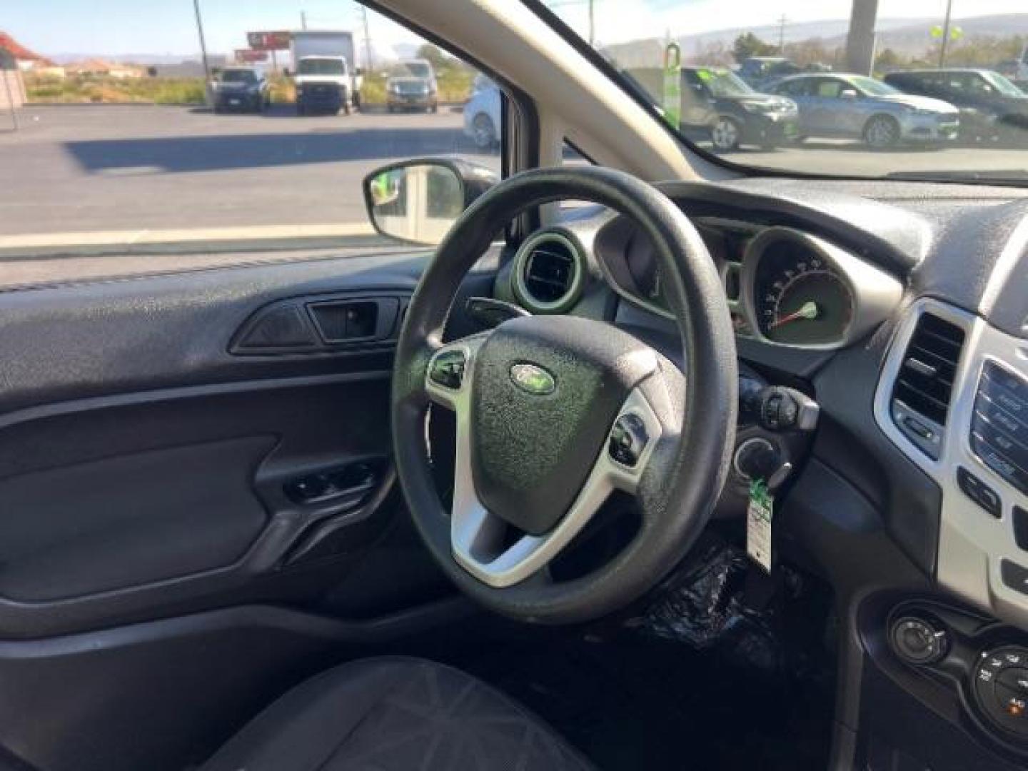 2012 Tuxedo Black Metallic /Charcoal Black/Light Stone Ford Fiesta SE (3FADP4BJ3CM) with an 1.6L I-4 DOHC engine, 5-Speed Manual transmission, located at 1865 East Red Hills Pkwy, St. George, 84770, (435) 628-0023, 37.120850, -113.543640 - Looking for a zippy, fuel-efficient car that is fun to drive and easy on your budget? This 2012 Ford Fiesta SE is just the ticket! Compact, stylish, and surprisingly well-equipped, this Fiesta comes loaded with air conditioning, heated front seats, chrome wheels, full size spare tire, deep tinted gl- Photo#28