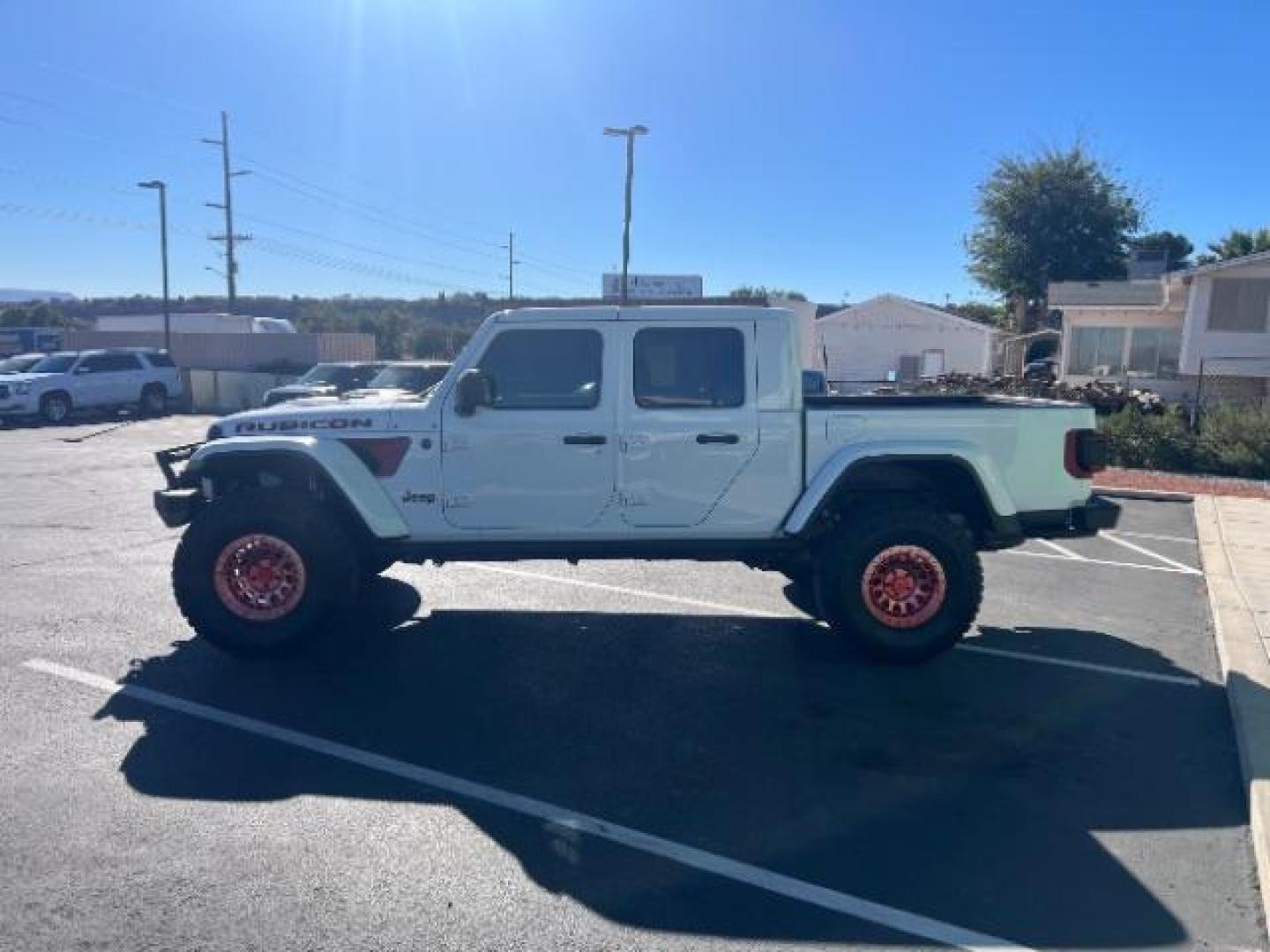 2021 Bright White Clearcoat /Red Jeep Gladiator Rubicon 4X4 (1C6JJTBG1ML) with an 3.6L V-6 DOHC engine, AUTOMATIC transmission, located at 1865 East Red Hills Pkwy, St. George, 84770, (435) 628-0023, 37.120850, -113.543640 - Classy red and white Gladiator rubicon with lift and tires. Great condition and drives straight. Specs: GVWR: 6,250 lbs w/Max Tow Package LED LIGHTING GROUP - AD6 Includes Daytime Running Lamps LED Accents LED Park Turn Lamps Front LED Fog Lamps LED Premium Reflector Headlamps LED Taillamps SA - Photo#3