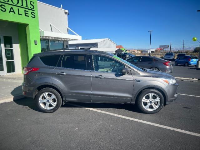 2014 Sterling Gray Metallic /Medium Light Stone Ford Escape SE (1FMCU9GX2EU) with an EcoBoost 1.6L I-4 gasoline direct injection engine, Automatic transmission, located at 940 North Main Street, Cedar City, UT, 84720, (435) 628-0023, 37.692936, -113.061897 - We specialize in helping ALL people get the best financing available. No matter your credit score, good, bad or none we can get you an amazing rate. Had a bankruptcy, divorce, or repossessions? We give you the green light to get your credit back on the road. Low down and affordable payments that fit - Photo#7