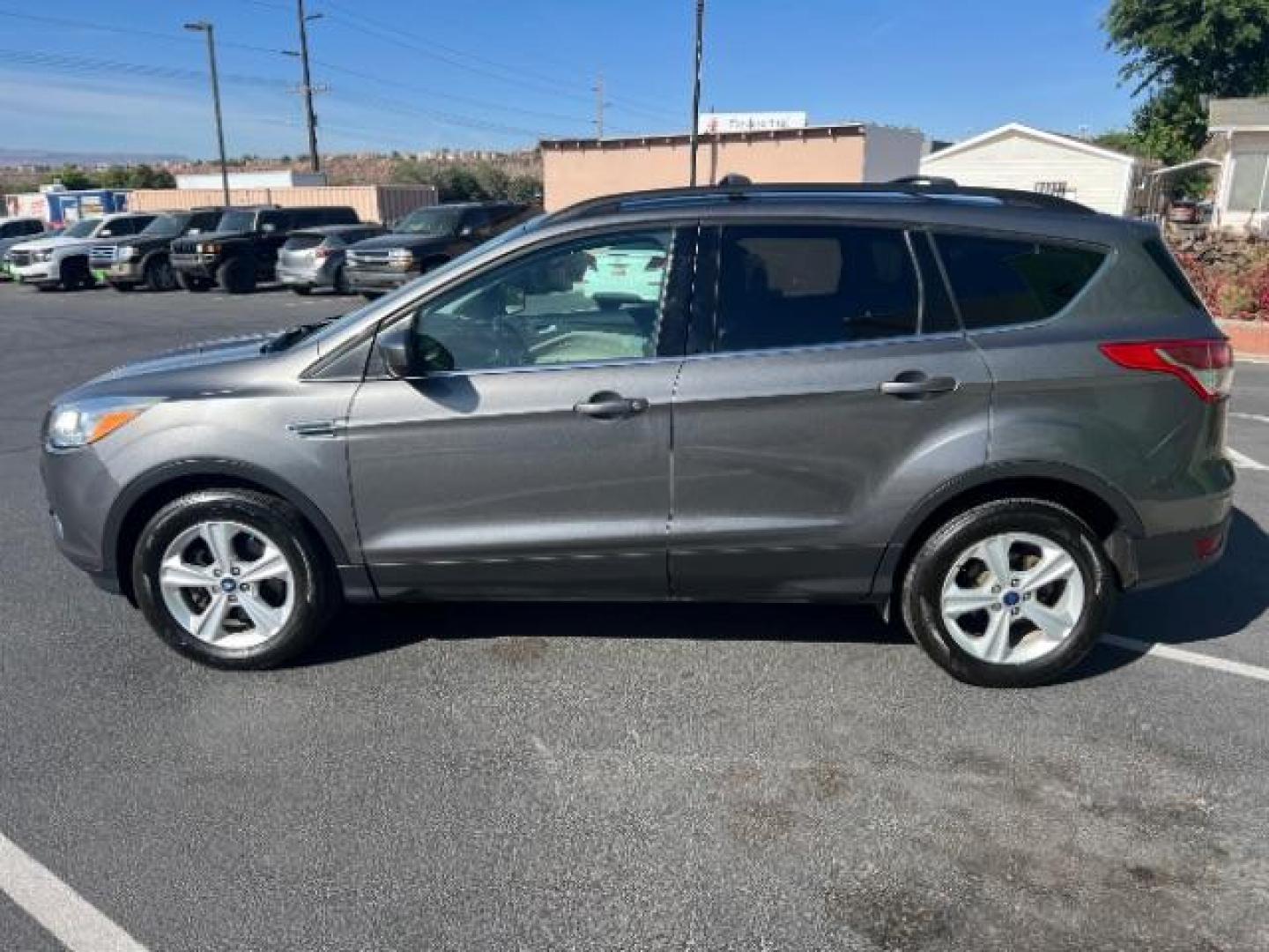 2014 Sterling Gray Metallic /Medium Light Stone Ford Escape SE (1FMCU9GX2EU) with an EcoBoost 1.6L I-4 gasoline direct injection engine, AUTOMATIC transmission, located at 940 North Main Street, Cedar City, UT, 84720, (435) 628-0023, 37.692936, -113.061897 - We specialize in helping ALL people get the best financing available. No matter your credit score, good, bad or none we can get you an amazing rate. Had a bankruptcy, divorce, or repossessions? We give you the green light to get your credit back on the road. Low down and affordable payments that fit- Photo#3