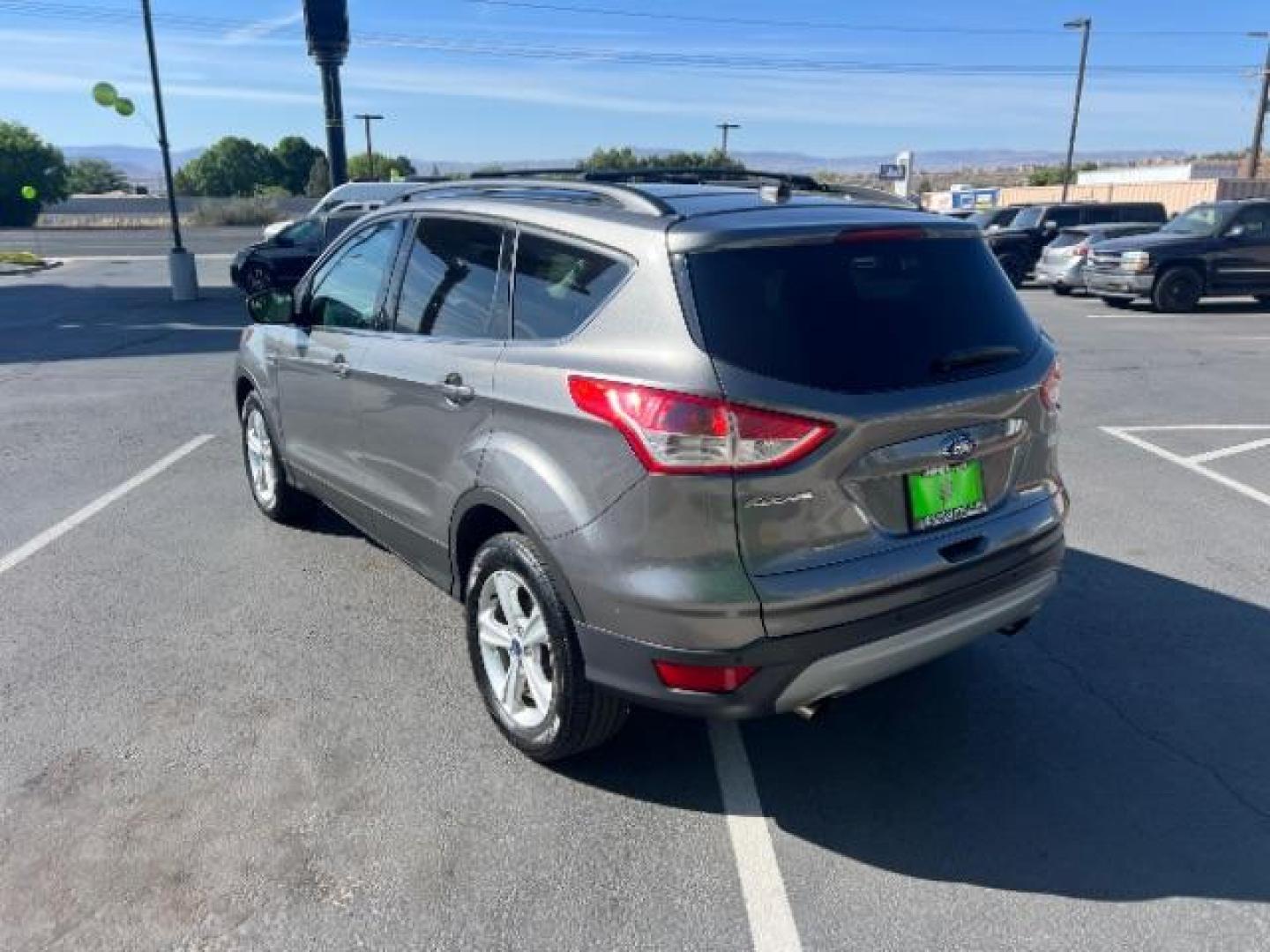 2014 Sterling Gray Metallic /Medium Light Stone Ford Escape SE (1FMCU9GX2EU) with an EcoBoost 1.6L I-4 gasoline direct injection engine, AUTOMATIC transmission, located at 940 North Main Street, Cedar City, UT, 84720, (435) 628-0023, 37.692936, -113.061897 - We specialize in helping ALL people get the best financing available. No matter your credit score, good, bad or none we can get you an amazing rate. Had a bankruptcy, divorce, or repossessions? We give you the green light to get your credit back on the road. Low down and affordable payments that fit- Photo#4