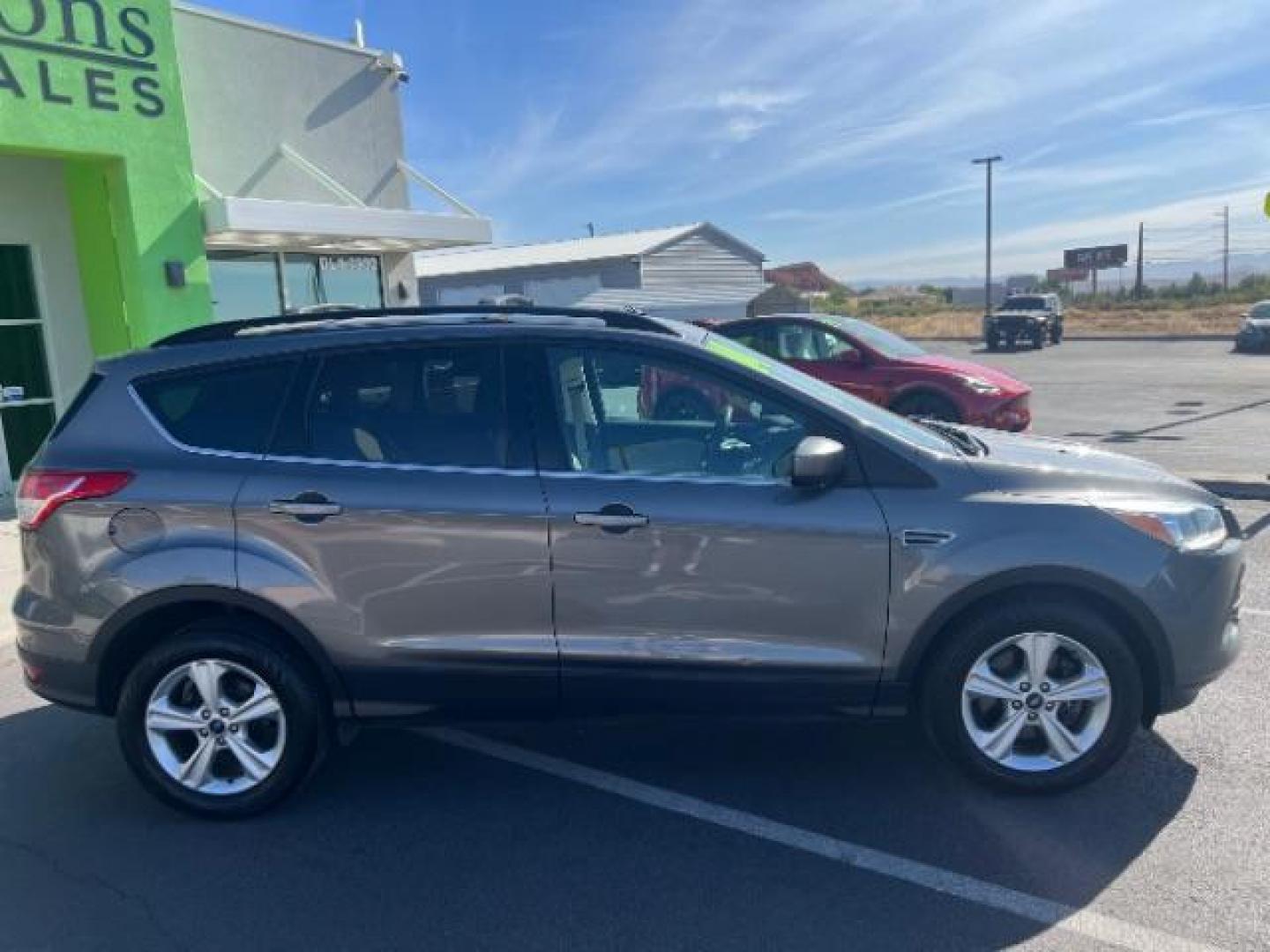 2014 Sterling Gray Metallic /Medium Light Stone Ford Escape SE (1FMCU9GX2EU) with an EcoBoost 1.6L I-4 gasoline direct injection engine, AUTOMATIC transmission, located at 940 North Main Street, Cedar City, UT, 84720, (435) 628-0023, 37.692936, -113.061897 - We specialize in helping ALL people get the best financing available. No matter your credit score, good, bad or none we can get you an amazing rate. Had a bankruptcy, divorce, or repossessions? We give you the green light to get your credit back on the road. Low down and affordable payments that fit- Photo#7