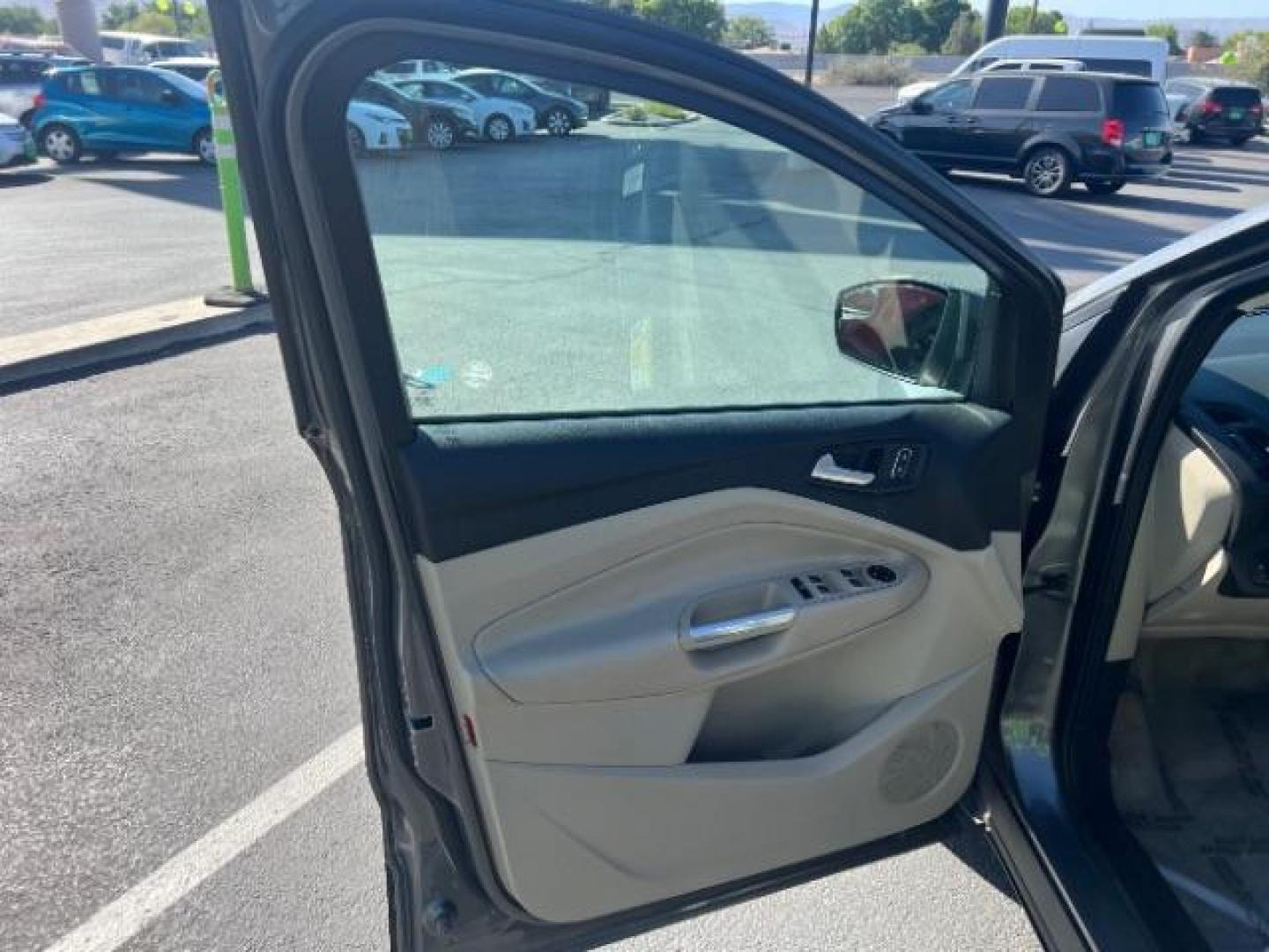 2014 Sterling Gray Metallic /Medium Light Stone Ford Escape SE (1FMCU9GX2EU) with an EcoBoost 1.6L I-4 gasoline direct injection engine, AUTOMATIC transmission, located at 940 North Main Street, Cedar City, UT, 84720, (435) 628-0023, 37.692936, -113.061897 - We specialize in helping ALL people get the best financing available. No matter your credit score, good, bad or none we can get you an amazing rate. Had a bankruptcy, divorce, or repossessions? We give you the green light to get your credit back on the road. Low down and affordable payments that fit- Photo#12