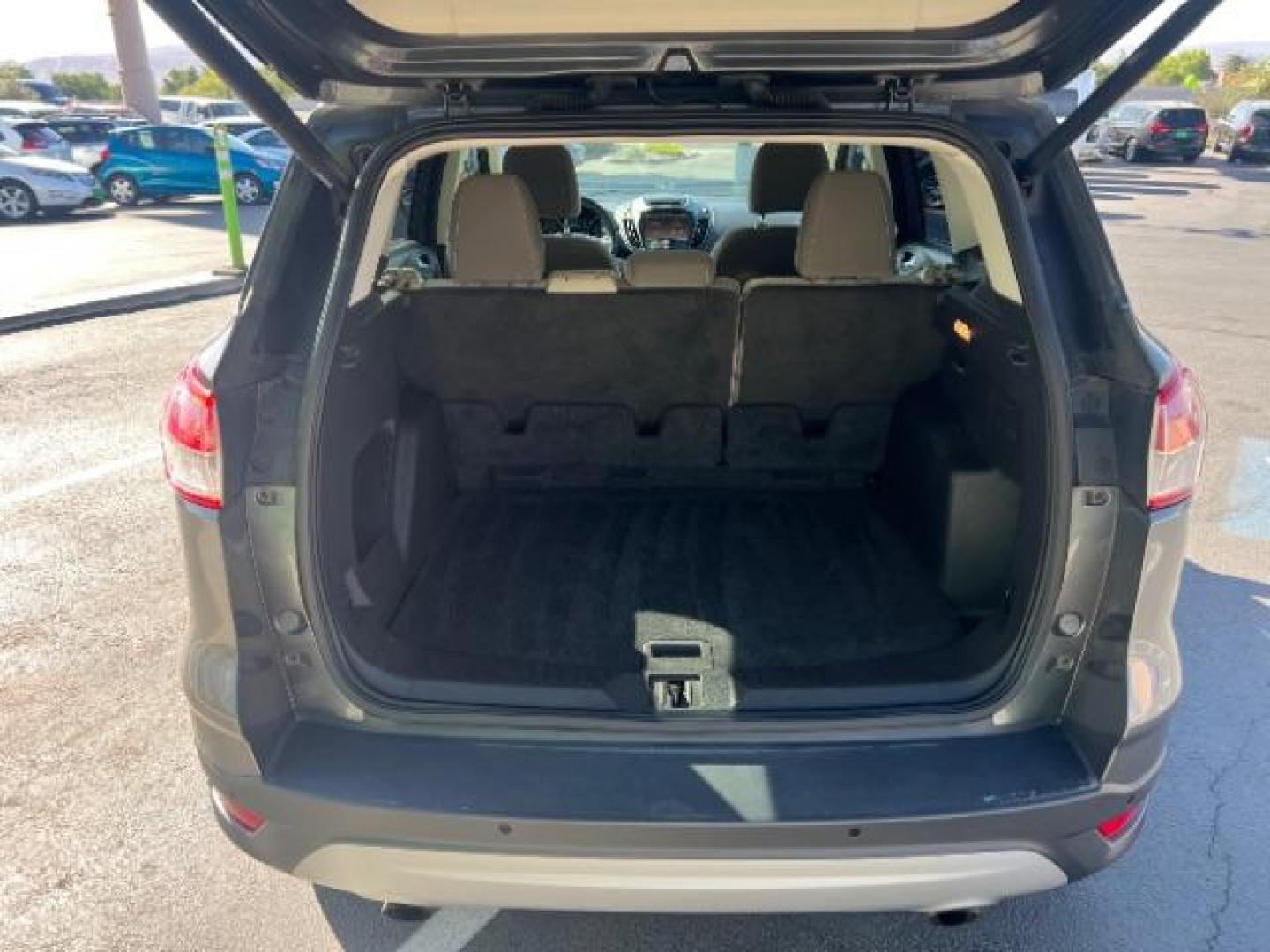 2014 Sterling Gray Metallic /Medium Light Stone Ford Escape SE (1FMCU9GX2EU) with an EcoBoost 1.6L I-4 gasoline direct injection engine, AUTOMATIC transmission, located at 940 North Main Street, Cedar City, UT, 84720, (435) 628-0023, 37.692936, -113.061897 - We specialize in helping ALL people get the best financing available. No matter your credit score, good, bad or none we can get you an amazing rate. Had a bankruptcy, divorce, or repossessions? We give you the green light to get your credit back on the road. Low down and affordable payments that fit- Photo#24