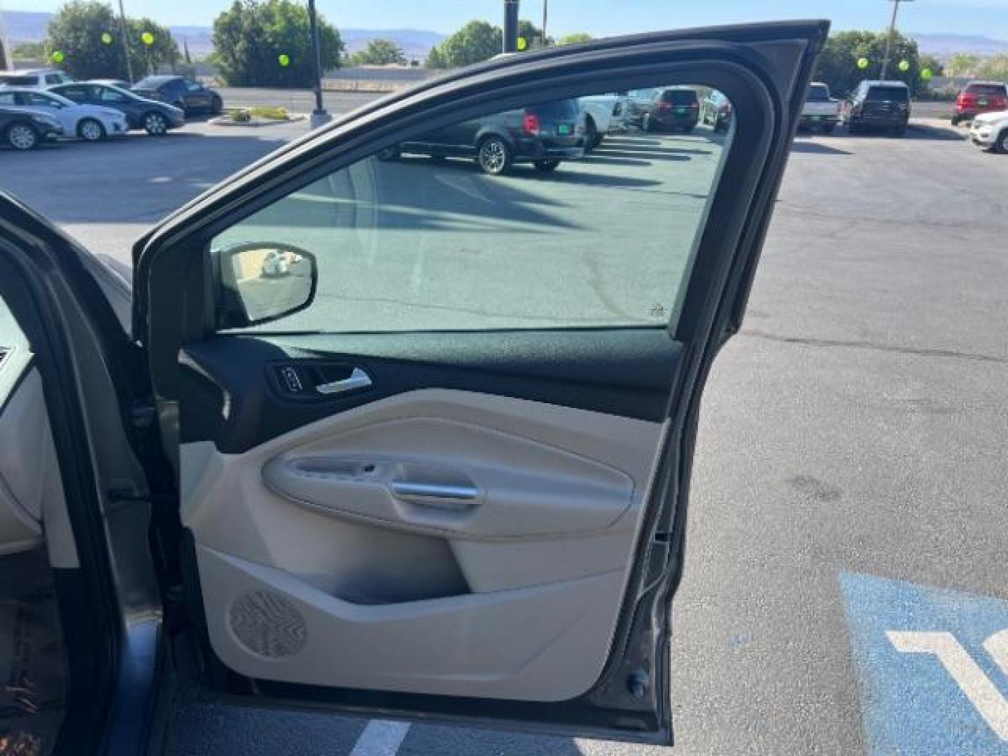 2014 Sterling Gray Metallic /Medium Light Stone Ford Escape SE (1FMCU9GX2EU) with an EcoBoost 1.6L I-4 gasoline direct injection engine, AUTOMATIC transmission, located at 940 North Main Street, Cedar City, UT, 84720, (435) 628-0023, 37.692936, -113.061897 - We specialize in helping ALL people get the best financing available. No matter your credit score, good, bad or none we can get you an amazing rate. Had a bankruptcy, divorce, or repossessions? We give you the green light to get your credit back on the road. Low down and affordable payments that fit- Photo#27