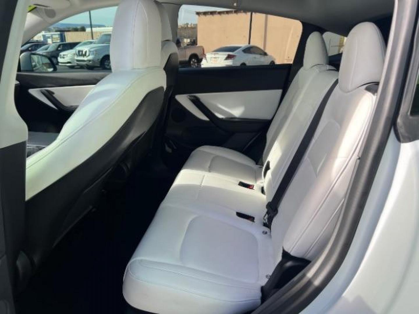 2021 White /White/Black Tesla Model Y Long Range Dual Motor All-Wheel Drive (5YJYGDEE5MF) with an ELECTRIC engine, Electric transmission, located at 1865 East Red Hills Pkwy, St. George, 84770, (435) 628-0023, 37.120850, -113.543640 - Excellent Tesla Model Y Long Range All Wheel Drive. With Full Self Drive paid for ($8k add on) Which is no longer available to buy. All our Teslas come with charging kit. Color changing wrap is a little rough but will still turn heads. Battery is healthy. Gets 275 on full charge. Clean title, no a - Photo#21