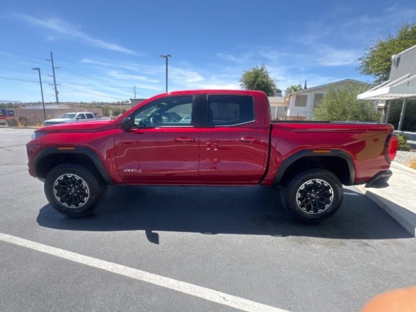 2026 Volcanic Red Tintcoat /Jet Black/Timber GMC Canyon AT4, 4WD (1GTP2DEK9T1) with an 2.7L I-4 direct injection engine, Automatic transmission, located at 1865 East Red Hills Pkwy, St. George, 84770, (435) 628-0023, 37.120850, -113.543640 - Practically new and ready for Southern Utah? This Volcanic Red Tintcoat 2026 GMC Canyon AT4 4WD brings a VIN-decoded 2.7L TurboMax 4-cylinder, 8-speed automatic, and confident 4x4 traction for daily driving, trailheads, and work. With only 13,031 miles, it has the look and capability of a fresh pick- Photo#3